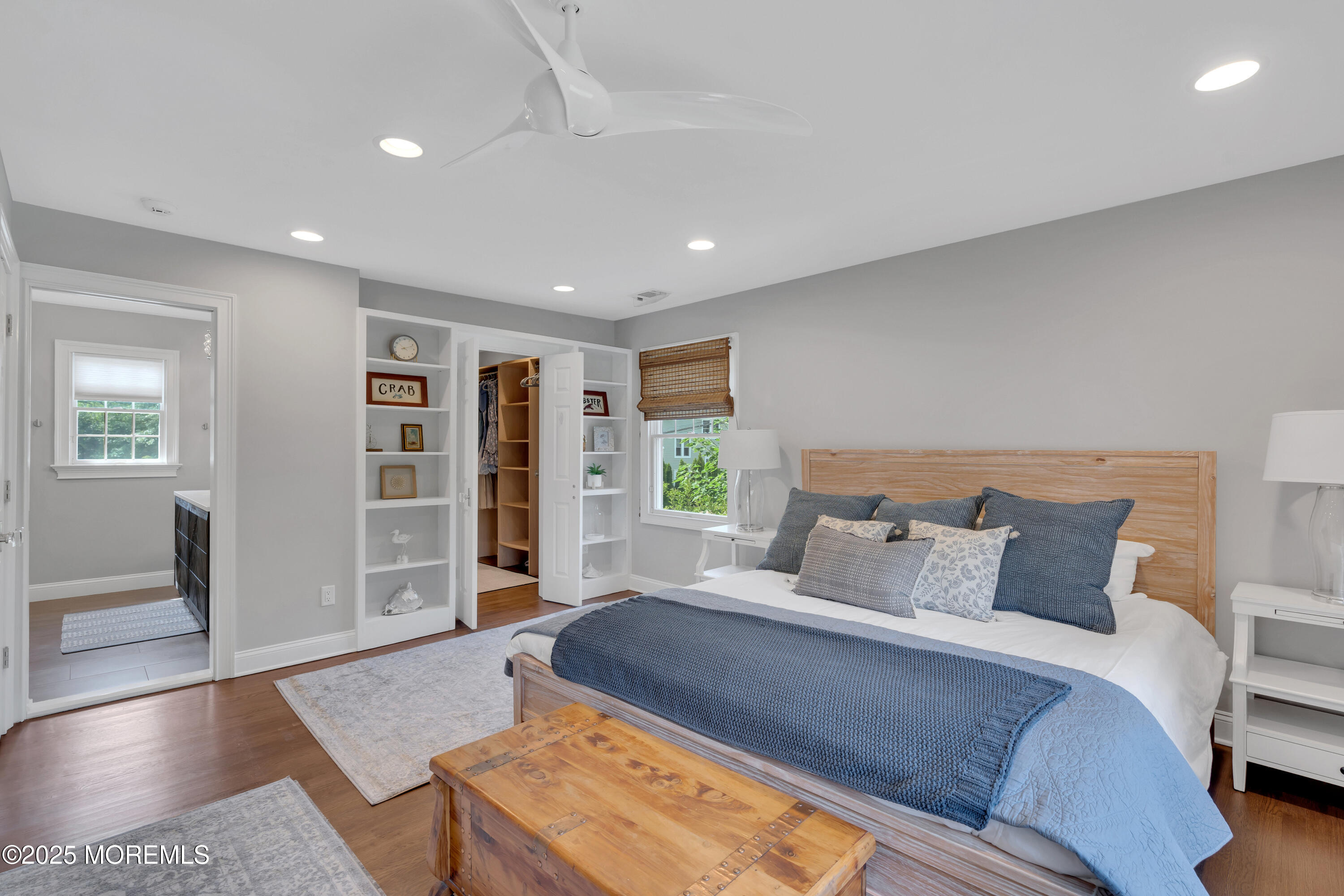 57 W River Road Rumson, NJ 07760 - Photo 13 of 44 a spacious bedroom with a large bed and a couch