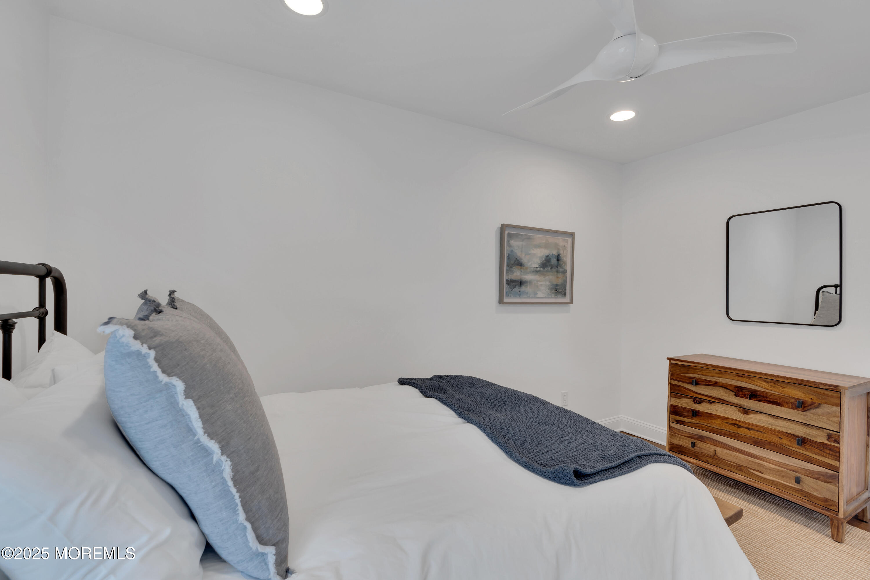 57 W River Road Rumson, NJ 07760 - Photo 22 of 44 a bedroom with a bed and a couch