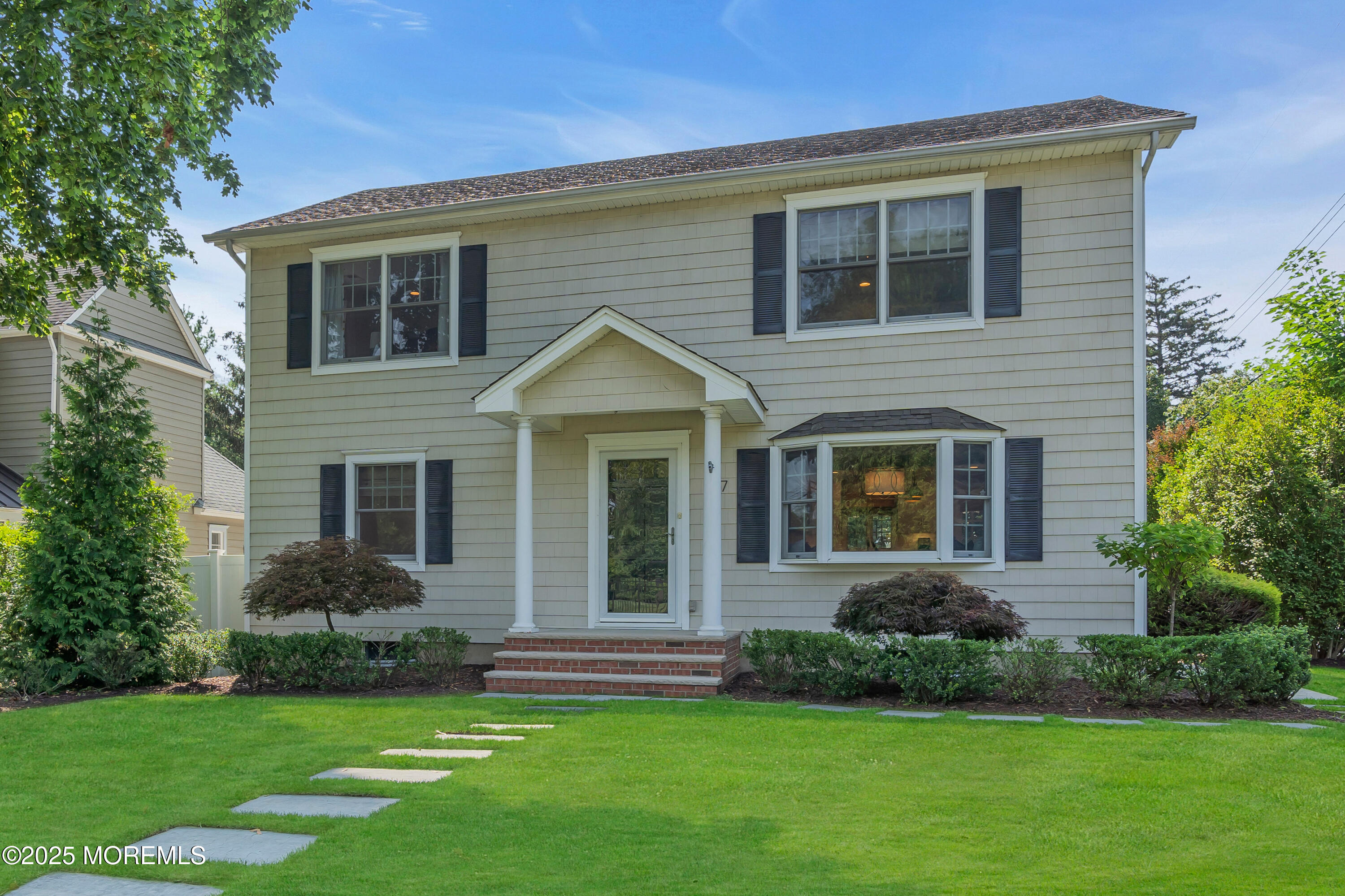 57 W River Road Rumson, NJ 07760 - Photo 30 of 44 a front view of a house with a yard and green space