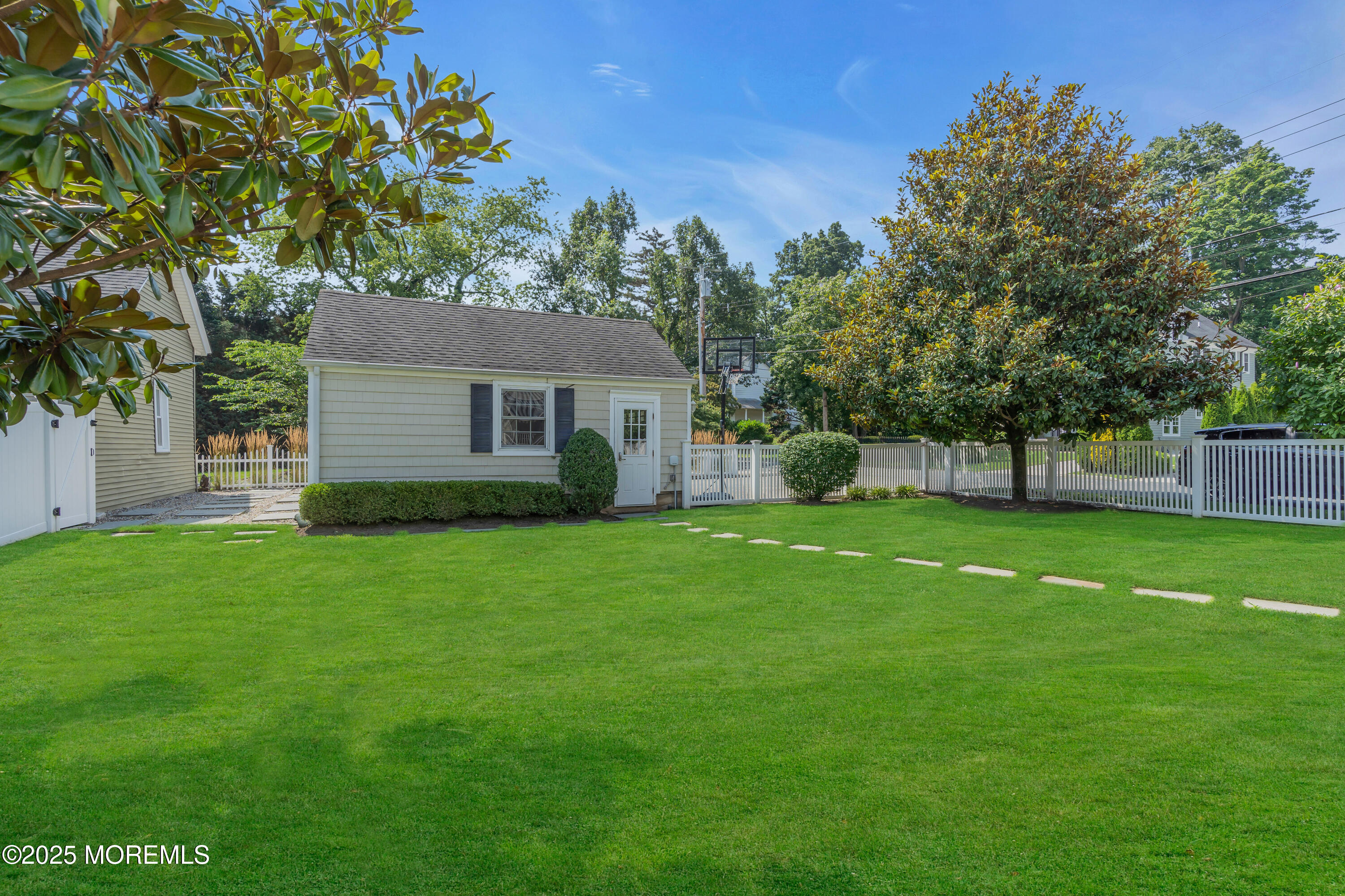 57 W River Road Rumson, NJ 07760 - Photo 37 of 44 a view of a house with backyard and a tree
