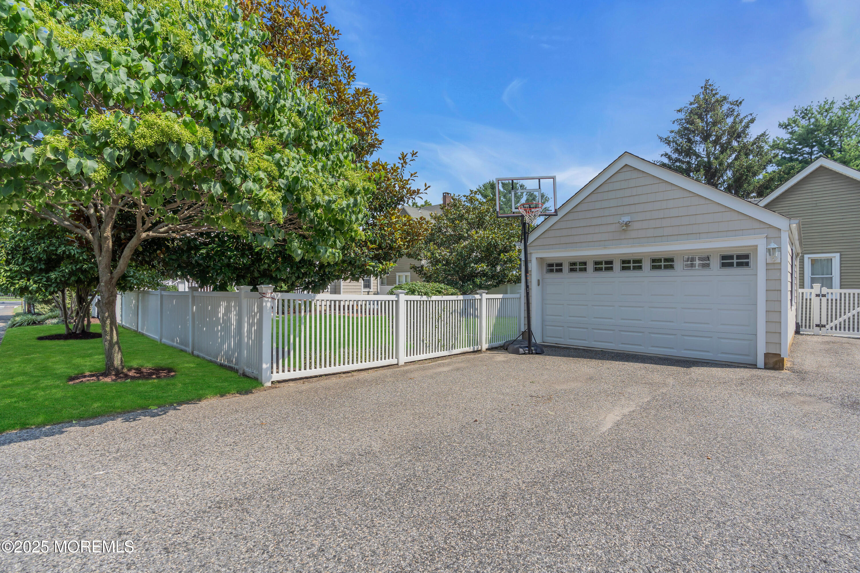 57 W River Road Rumson, NJ 07760 - Photo 39 of 44 a view of a house with a small yard and a large tree
