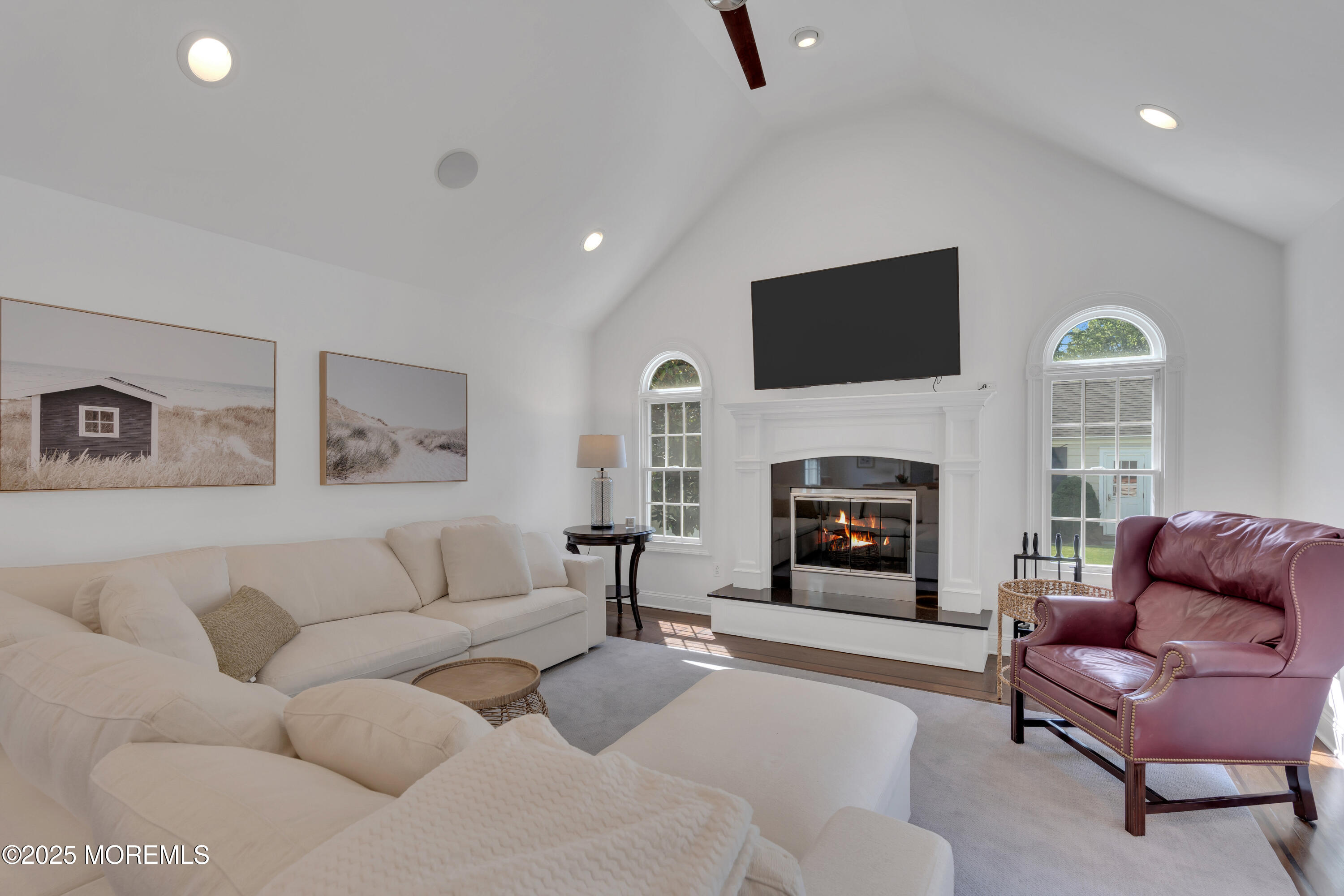 57 W River Road Rumson, NJ 07760 - Photo 10 of 44 a living room with furniture a flat screen tv and a fireplace