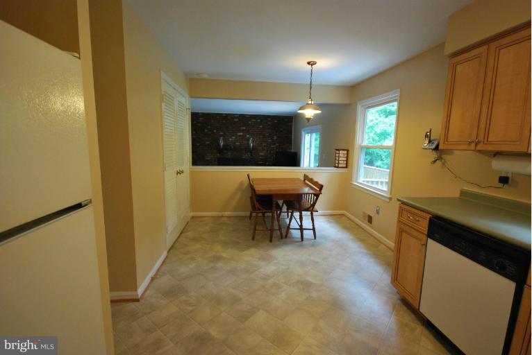 13628 Middlevale Lane Silver Spring, MD 20906 - Photo 1 of 25 a view of a kitchen with a table and chairs