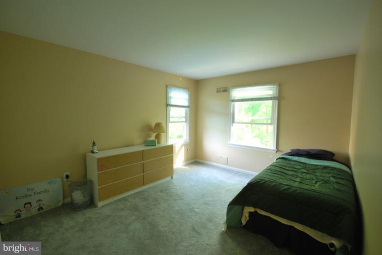 13628 Middlevale Lane Silver Spring, MD 20906 - Photo 11 of 25 a bed room with a bed and a window