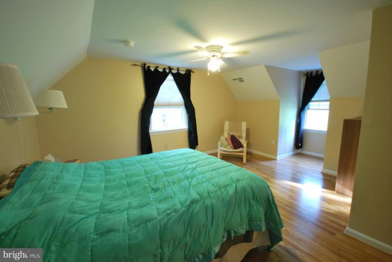 13628 Middlevale Lane Silver Spring, MD 20906 - Photo 12 of 25 a bedroom with a bed and a mirror