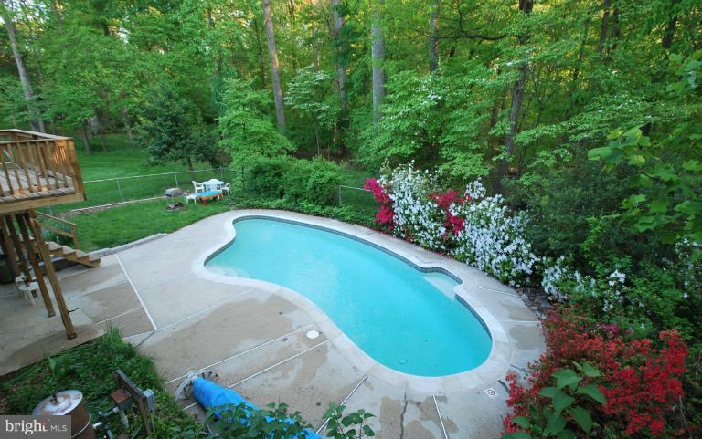 13628 Middlevale Lane Silver Spring, MD 20906 - Photo 17 of 25 a view of a swimming pool with a yard