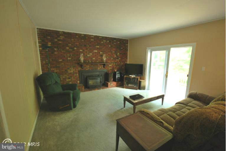13628 Middlevale Lane Silver Spring, MD 20906 - Photo 18 of 25 a living room with furniture and a fireplace