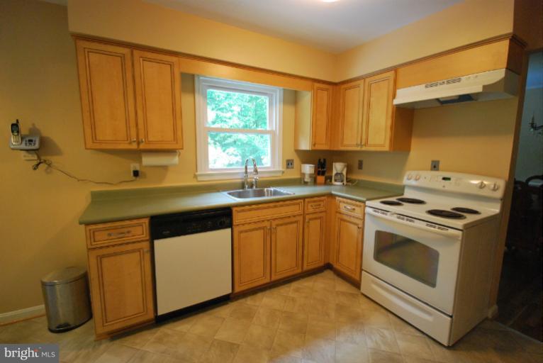 13628 Middlevale Lane Silver Spring, MD 20906 - Photo 24 of 25 a kitchen with a sink stove and cabinets
