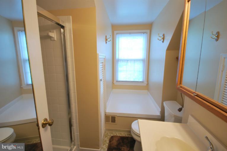 13628 Middlevale Lane Silver Spring, MD 20906 - Photo 4 of 25 a bathroom with a sink and a mirror