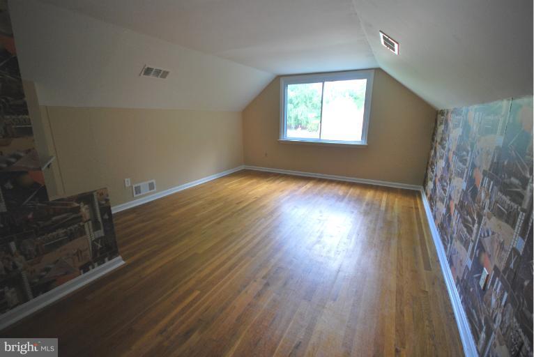 13628 Middlevale Lane Silver Spring, MD 20906 - Photo 5 of 25 wooden floor in an empty room with a window