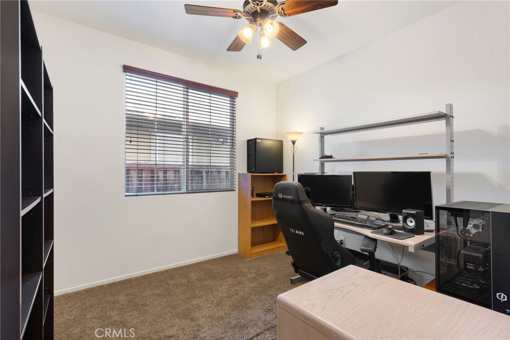 46545 Peach Tree Street Temecula, CA 92592 - Photo 15 of 48 a living room with furniture a fireplace and a flat screen tv