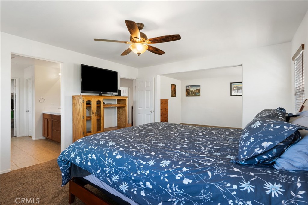 46545 Peach Tree Street Temecula, CA 92592 - Photo 26 of 48 a bedroom with a bed and a flat screen tv