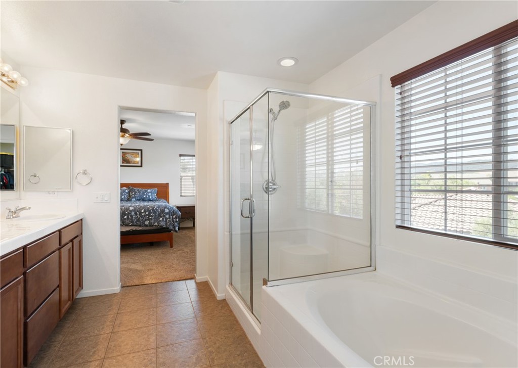 46545 Peach Tree Street Temecula, CA 92592 - Photo 29 of 48 a en suite bathroom with a granite countertop tub sink and shower