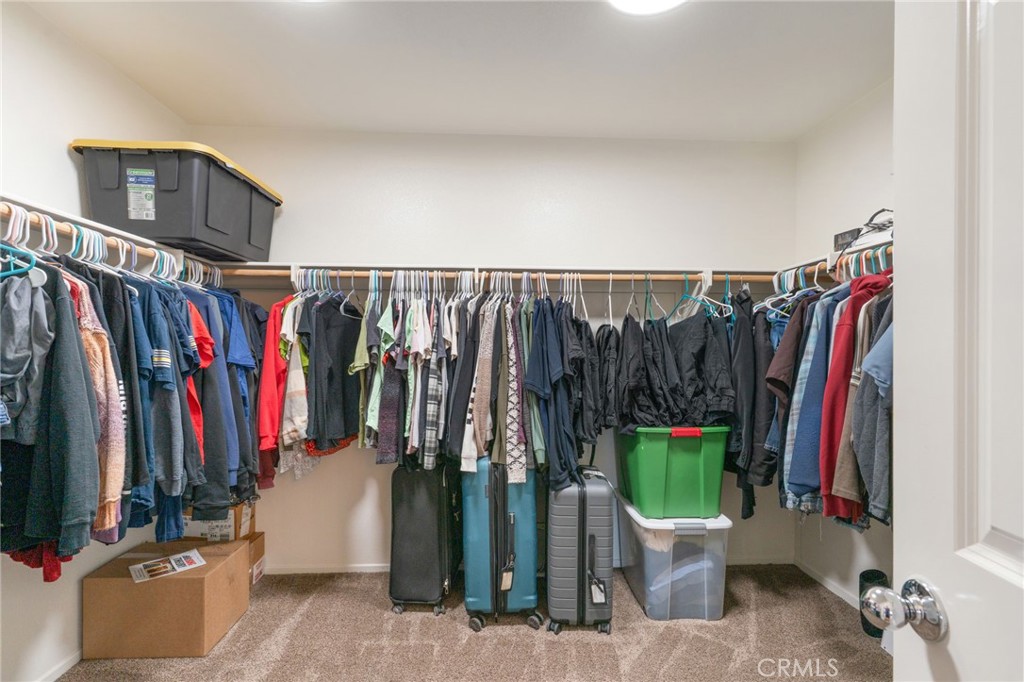46545 Peach Tree Street Temecula, CA 92592 - Photo 31 of 48 a view of walk in closet with clothes