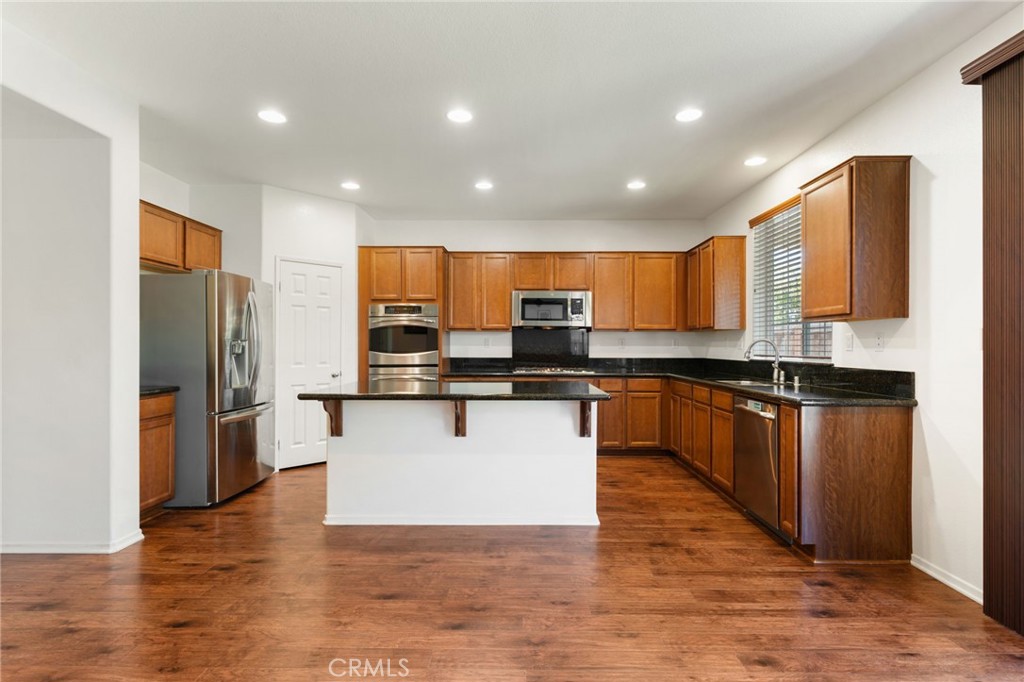 46545 Peach Tree Street Temecula, CA 92592 - Photo 8 of 48 a kitchen with stainless steel appliances granite countertop a refrigerator a sink and a microwave