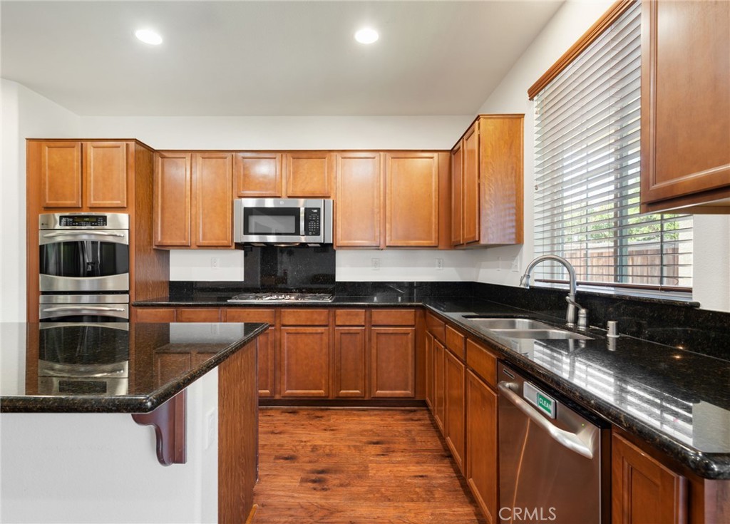 46545 Peach Tree Street Temecula, CA 92592 - Photo 10 of 48 a kitchen with stainless steel appliances granite countertop a sink stove microwave and cabinets
