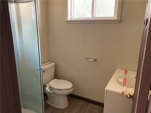 a white toilet sitting next to a small sink