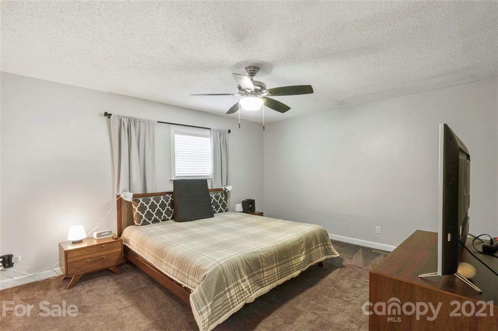 167 Mooreland Road, Unit 94 Mooresville, NC 28117 - Photo 12 of 34 a bedroom with a bed and a flat screen tv