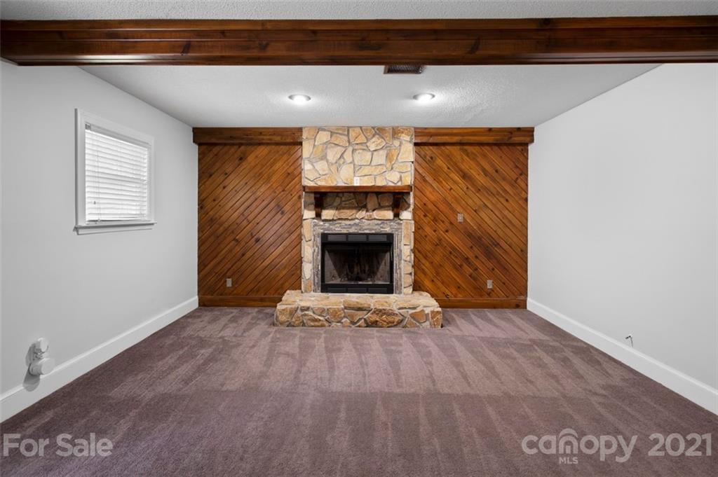 167 Mooreland Road, Unit 94 Mooresville, NC 28117 - Photo 18 of 34 a view of an empty room with a fireplace and a window