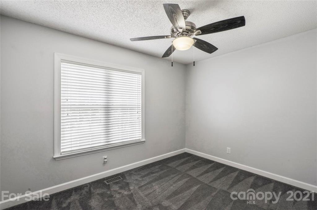 167 Mooreland Road, Unit 94 Mooresville, NC 28117 - Photo 20 of 34 an empty room with a window and a fan