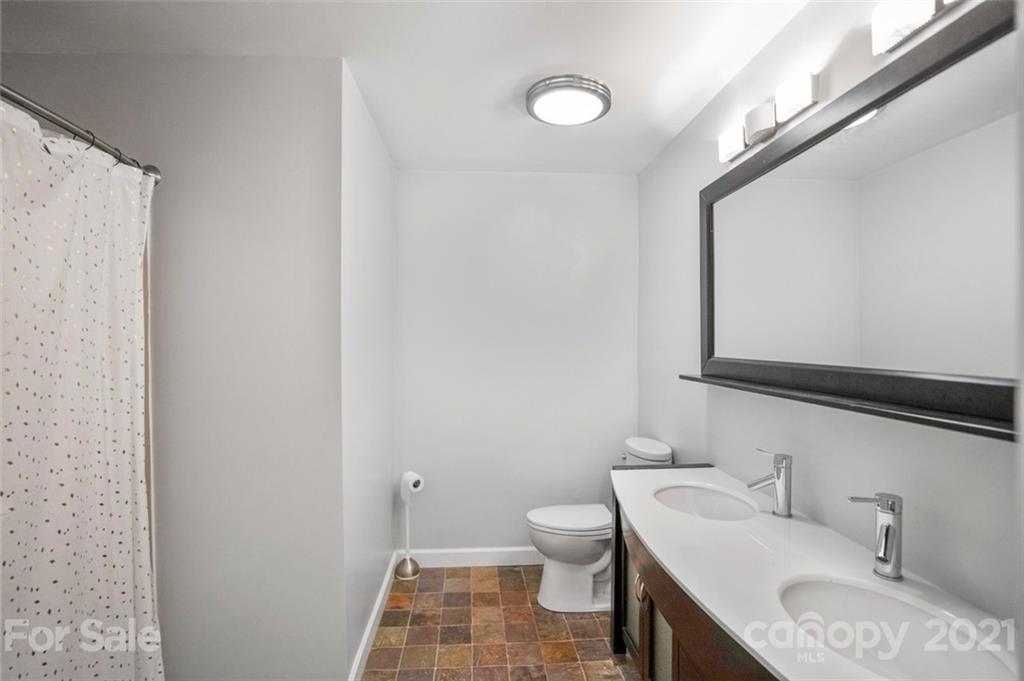 167 Mooreland Road, Unit 94 Mooresville, NC 28117 - Photo 26 of 34 a bathroom with a granite countertop sink mirror vanity and toilet