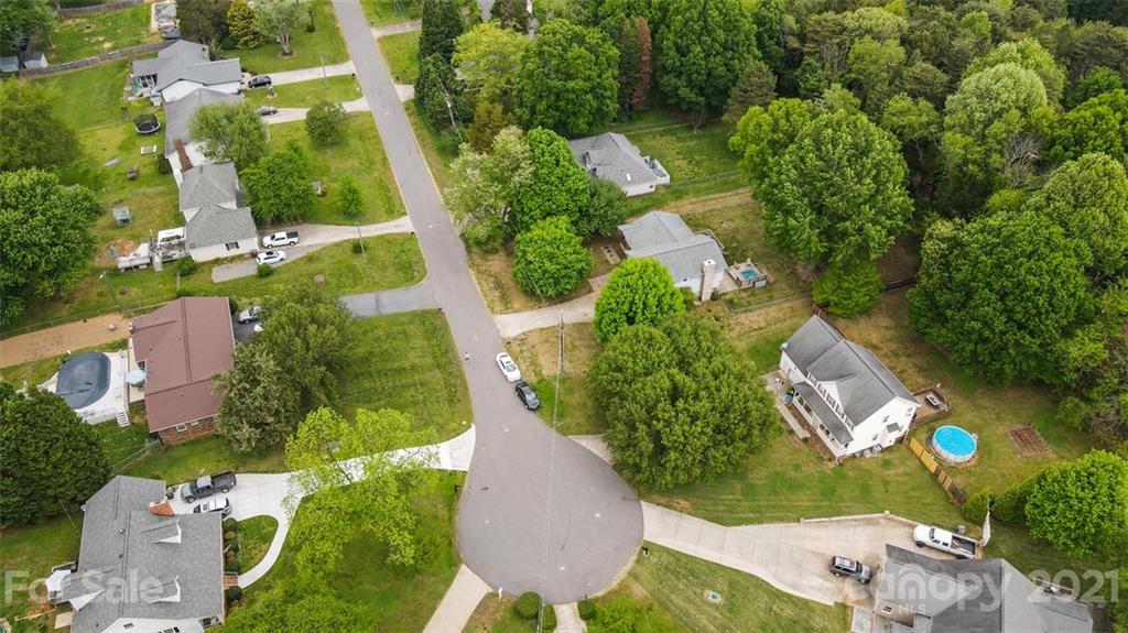 167 Mooreland Road, Unit 94 Mooresville, NC 28117 - Photo 32 of 34 an aerial view of a house with a yard and lake view