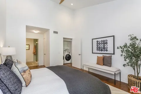 a bedroom with a bed and a couch