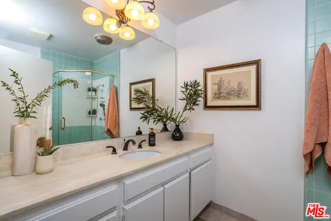 a bathroom with a sink a large mirror and vanity