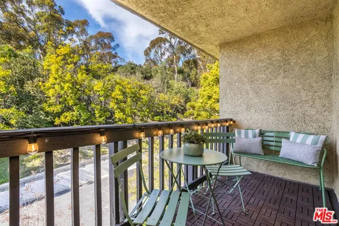 a balcony with wooden floor and fence