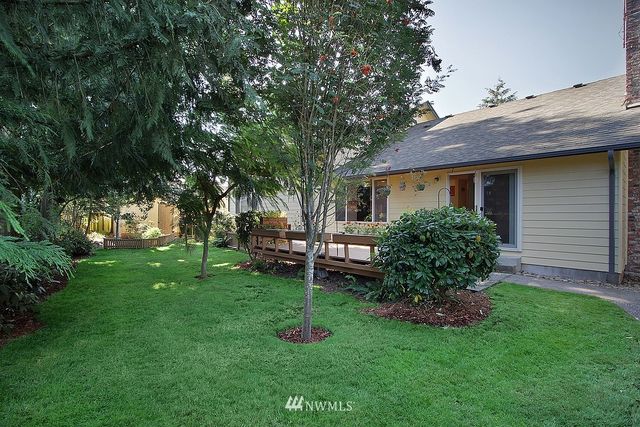 a view of a house with a backyard
