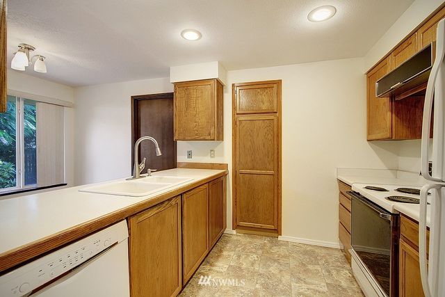 a kitchen that has a sink and a stove