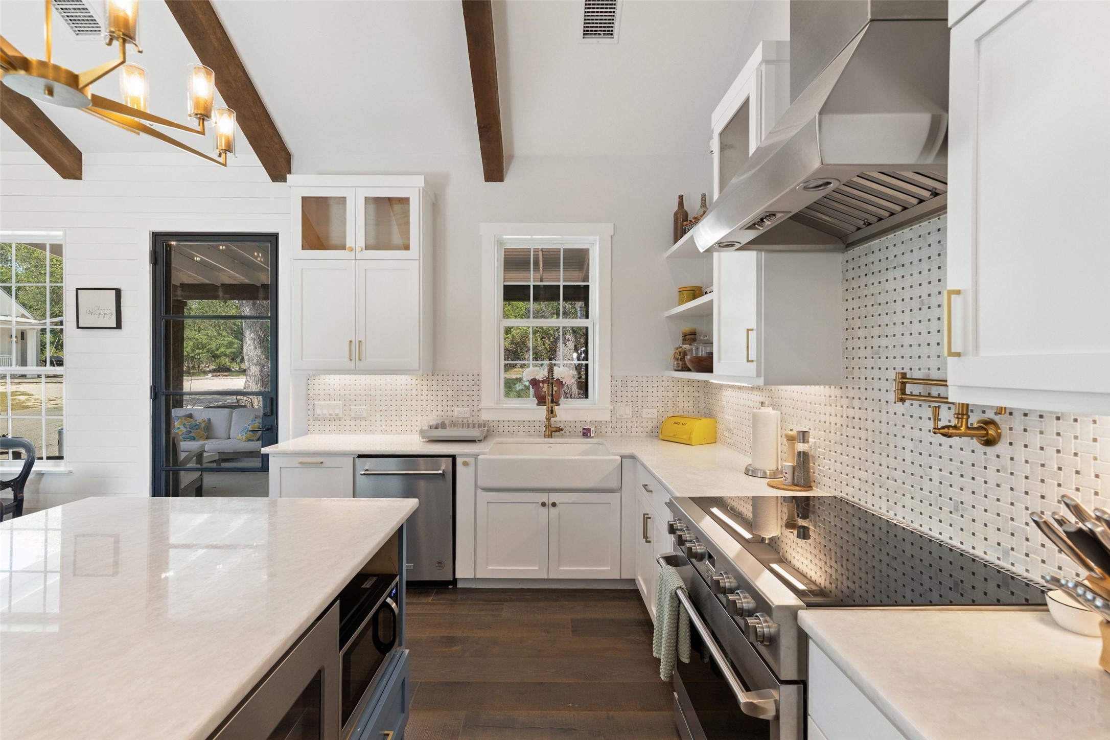 810 Kothmann Road Dripping Springs, TX 78620 - Photo 14 of 40 Exposed wood beams and a large central island anchor this gourmet kitchen space.
