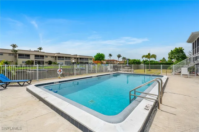 a view of a swimming pool with a lounge chair