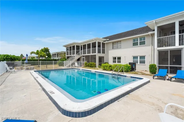 a view of a house with swimming pool and sitting area