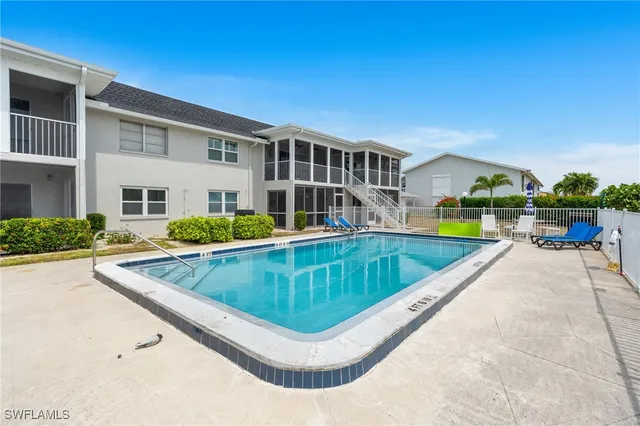 a view of swimming pool with outdoor seating