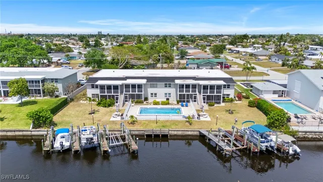 an aerial view of a house with swimming pool and outdoor seating