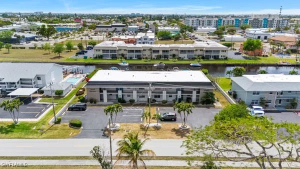 an aerial view of a swimming pool and outdoor seating