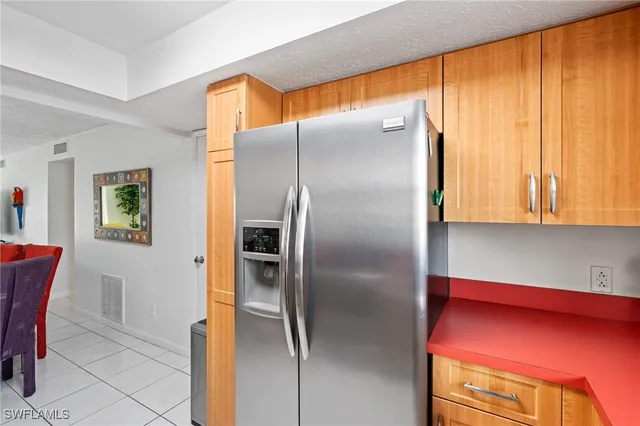 a kitchen with a refrigerator and table