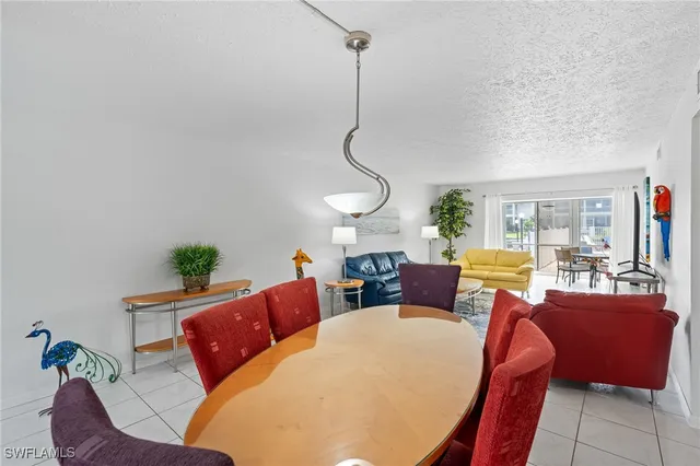 a living room with furniture a couch and chandelier