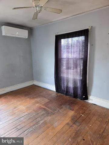 a view of a livingroom with a ceiling fan and window