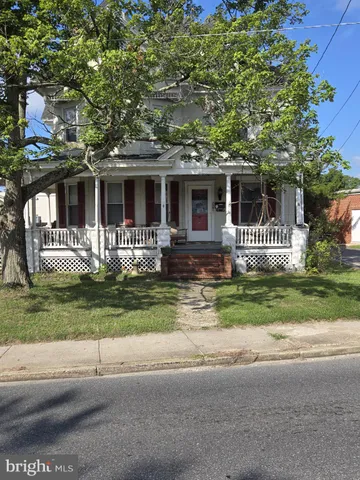 a front view of house with a garden and porch