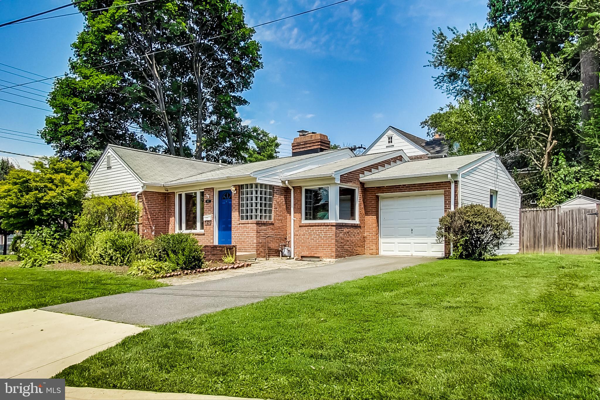 a front view of a house with a garden and yard