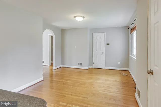 a view of an empty room with glass door