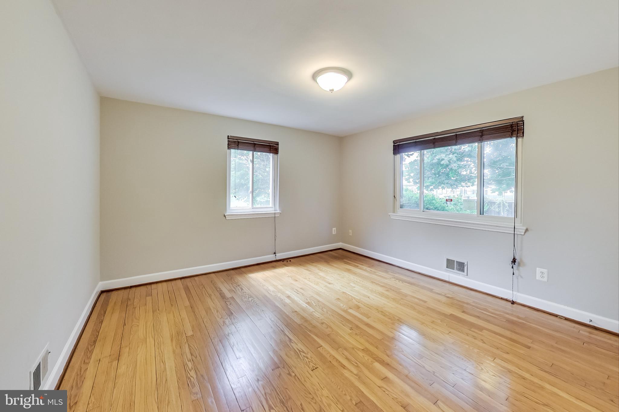 8617 Lynbrook Drive Bethesda, MD 20814 - Photo 23 of 48 an empty room with wooden floor and windows