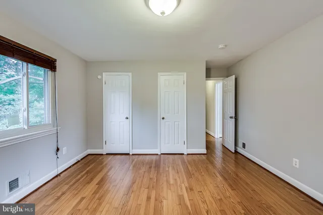 a view of a room with wooden floor and window