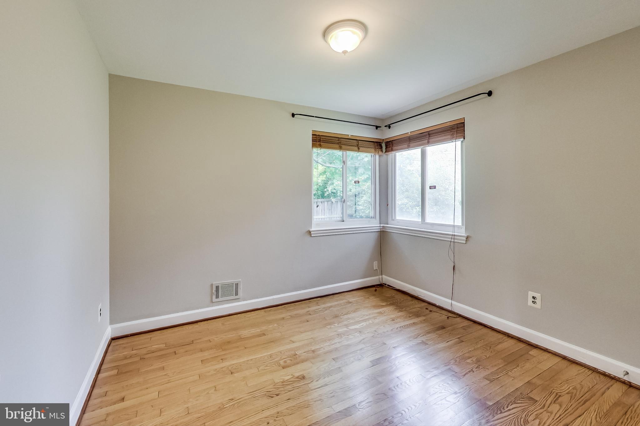 8617 Lynbrook Drive Bethesda, MD 20814 - Photo 25 of 48 an empty room with wooden floor and windows