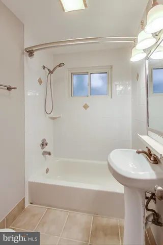 a bathroom with a sink a mirror and a bathtub