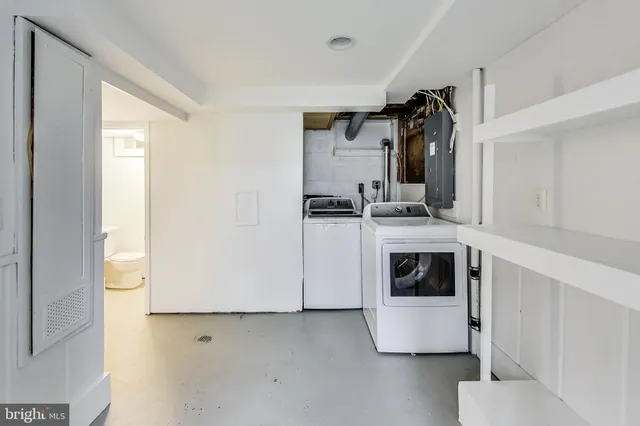 a kitchen with stainless steel appliances a stove and white cabinets
