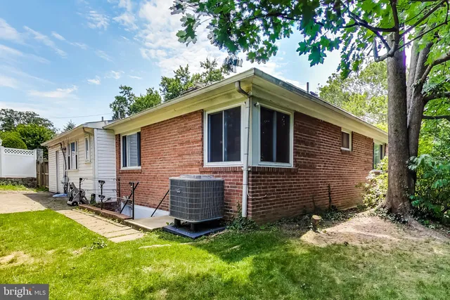 a backyard of a house with yard and outdoor seating