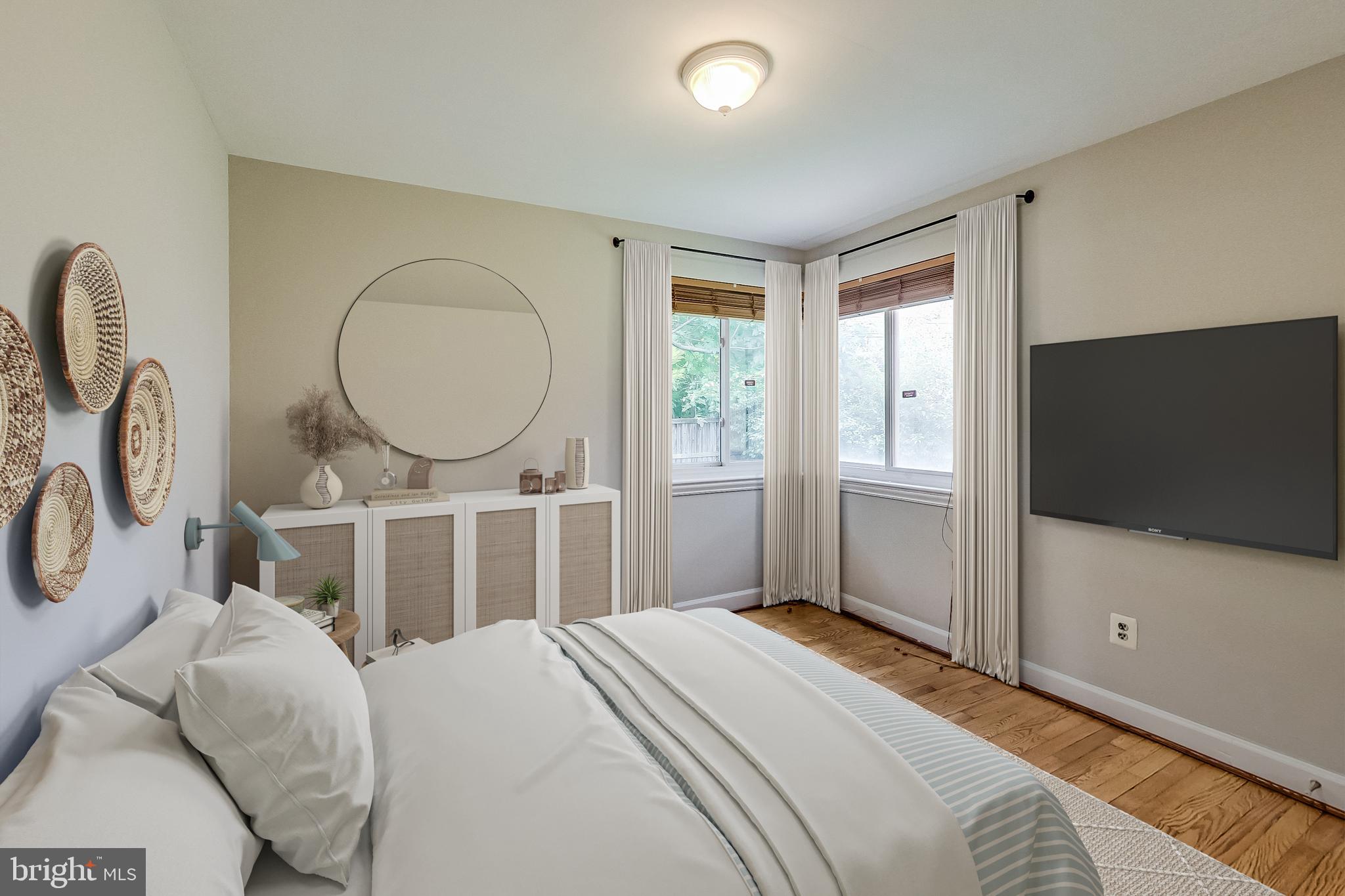 8617 Lynbrook Drive Bethesda, MD 20814 - Photo 7 of 48 a bedroom with a bed and a flat screen tv